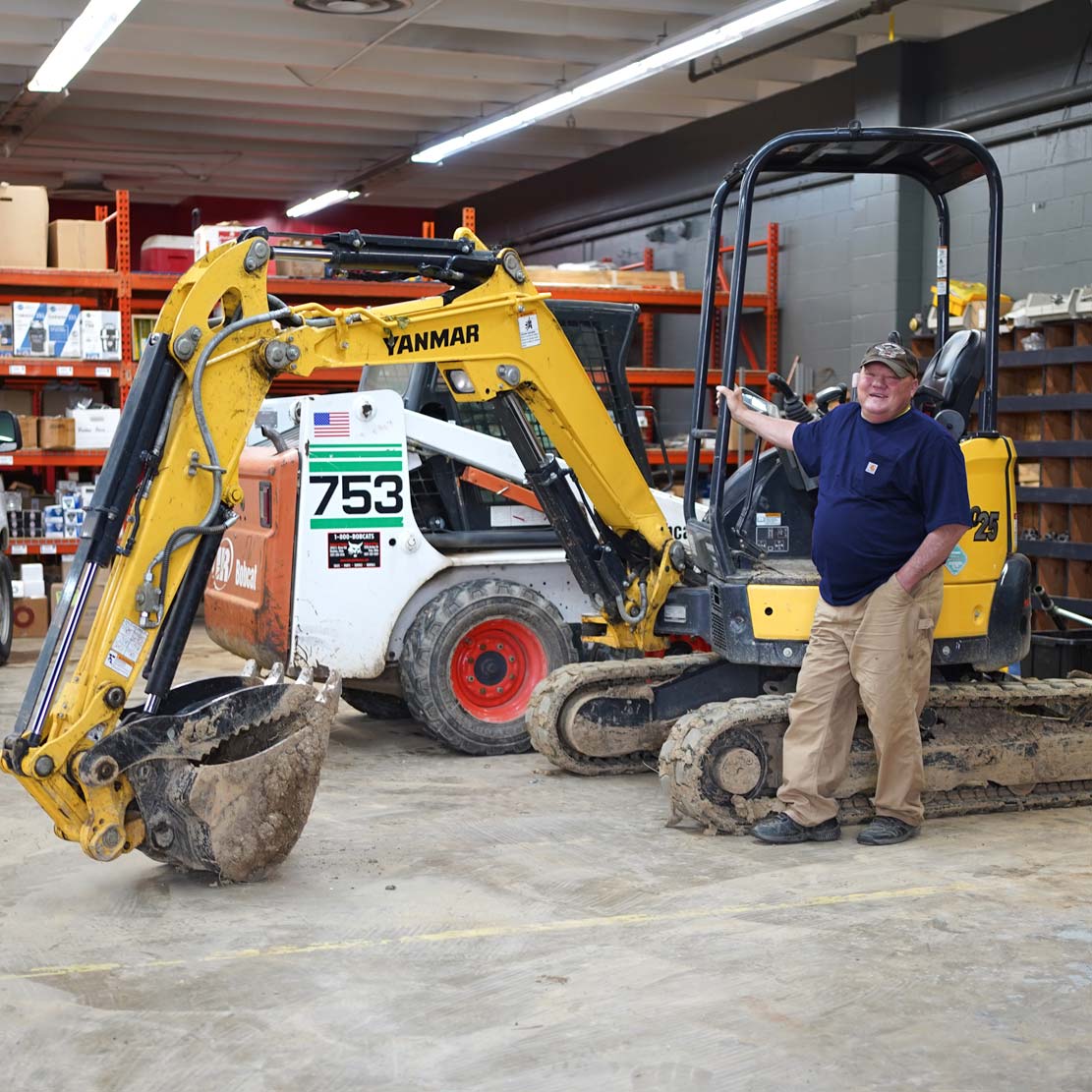 Man next to an excavator