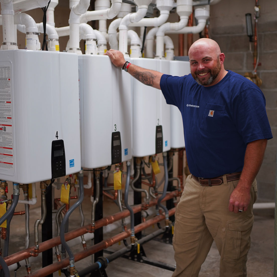 Plumber next to a Water Heater