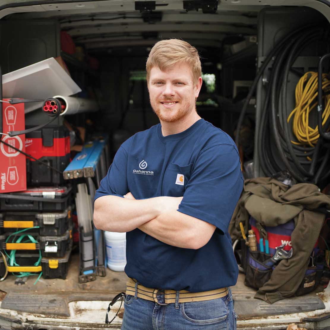 Plumber in front of tools in a van