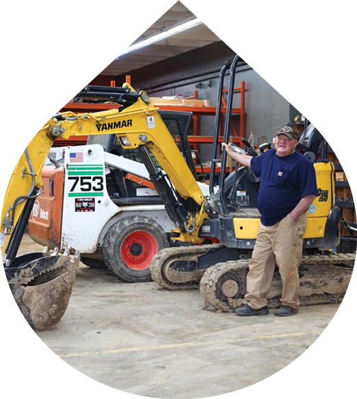 Plumber in front of an excavator