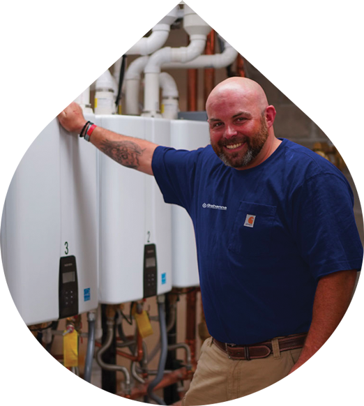 Plumber in front of tankless water heaters