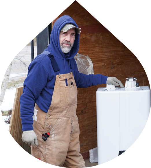 Plumber in front of a Tankless Water Heater